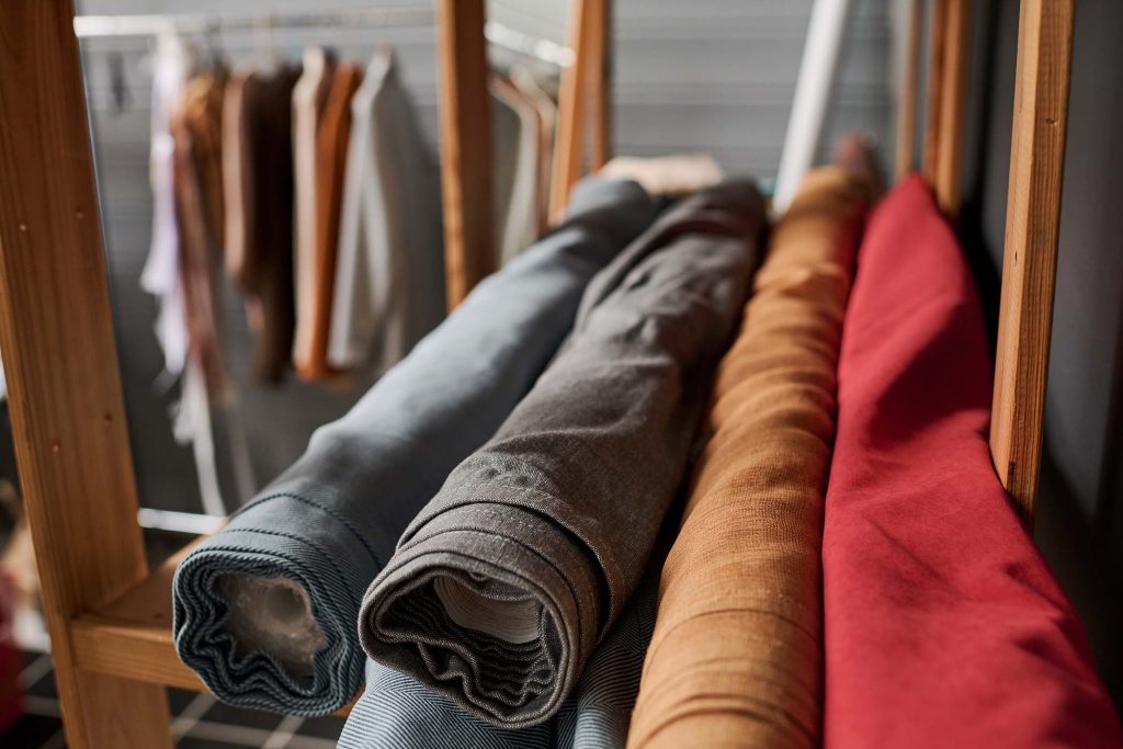 stack-of-rolls-of-several-natural-textiles-on-wood-SJAAPVS.jpg